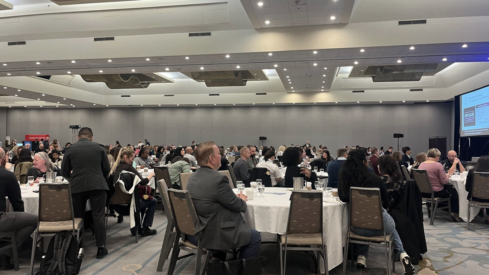 A full ballroom of delegates seated for an I4PL general session