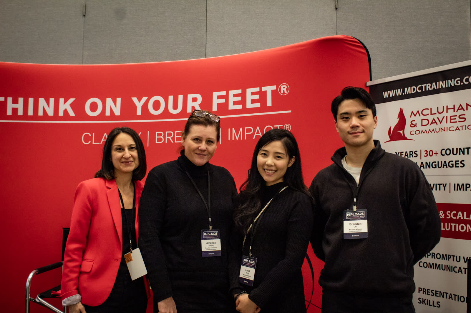 I4PL delegates and partners at an exhibitor booth on the conference floor