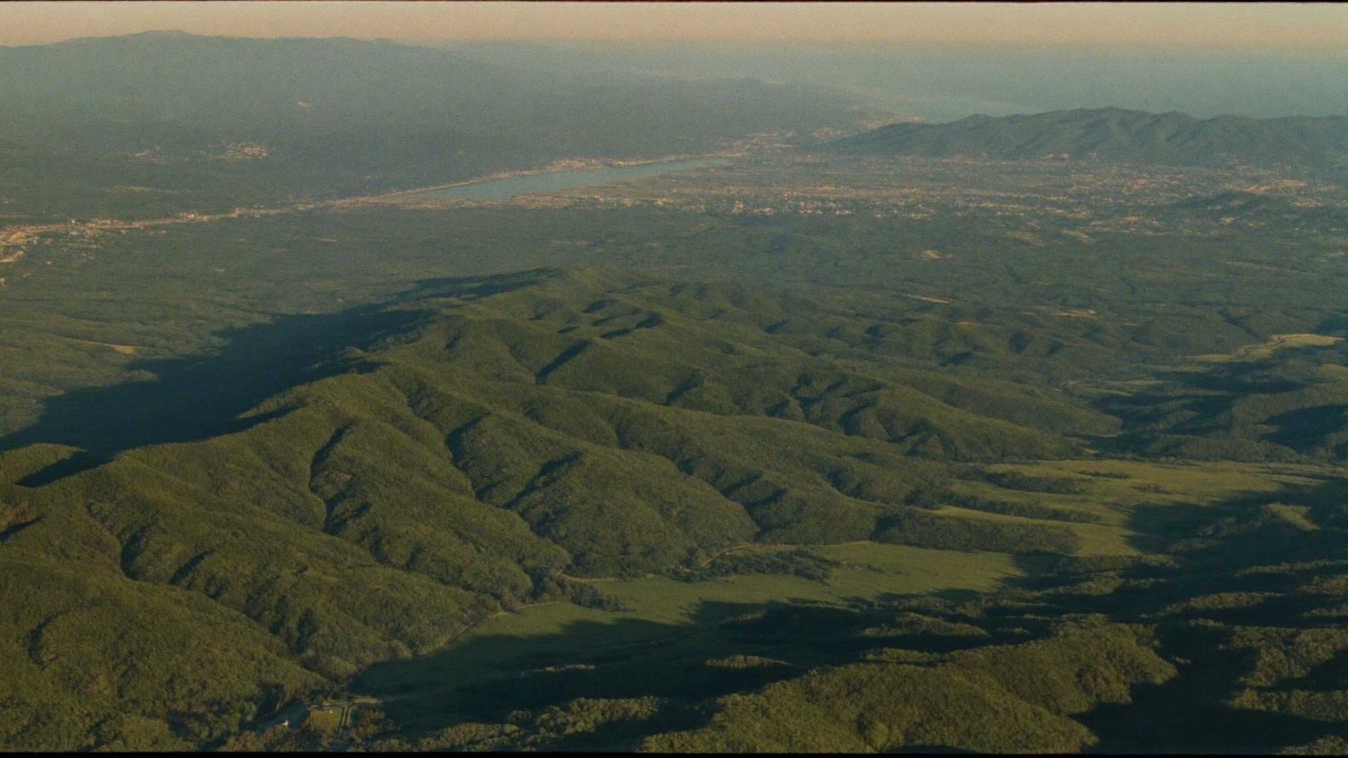 Aerial view of the Canadian landscape at golden hour, suggesting a national community.