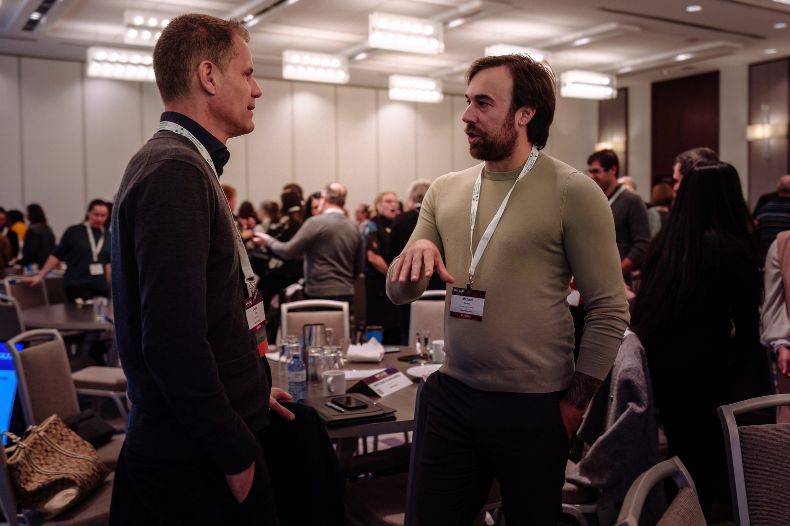 Two members in conversation between sessions at an I4PL event.